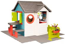 Kleine Spielhäuser für Kinder - Häuschen mit Gartenrestaurant Chef House DeLuxe Smoby mit Tisch und Vorgarten auf dem Boden_0